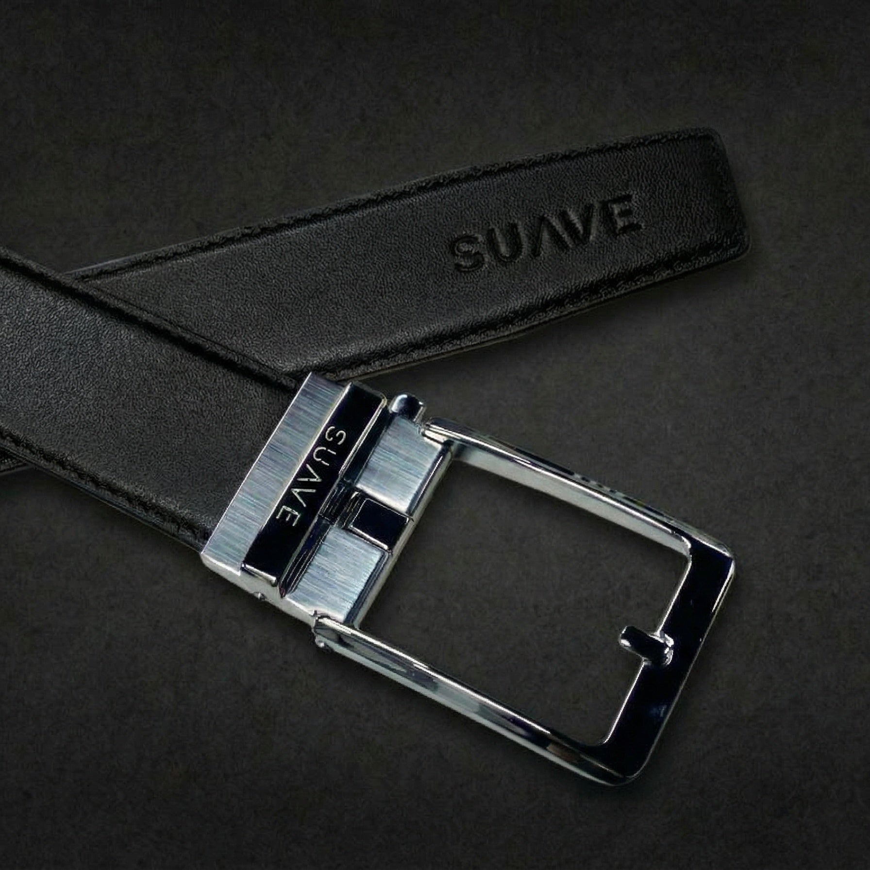 Black belt with silver buckle on a dark background